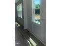 Hallway featuring white walls, natural light, wood floor, and decorative molding at 28 Carteret Ct # 56, Clayton, NC 27527