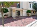 Building entrance showcasing a brick walkway, manicured landscaping, and double doors at 2813 Market Bridge Ln # 104, Raleigh, NC 27608