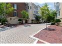 Exterior view showcasing brick walkways and manicured landscaping around apartment buildings at 2813 Market Bridge Ln # 104, Raleigh, NC 27608