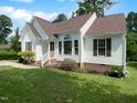 Single Gathering home with well maintained lawn and shrubbery, complemented by inviting front entrance at 3509 Neptune Dr, Raleigh, NC 27604