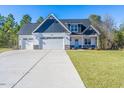 Spacious two-story house with a three-car garage and well-maintained front yard at 355 Shaw Rd, Cameron, NC 28326