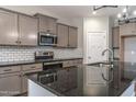Modern kitchen featuring granite counters, stainless steel appliances, and ample cabinet space at 355 Shaw Rd, Cameron, NC 28326