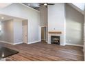 Open-concept living room with a modern fireplace, high ceilings, and wood-look floors at 355 Shaw Rd, Cameron, NC 28326
