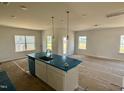 Bright and airy kitchen with a large island, pendant lighting, and ample natural light at 40 Commons Cir, Clayton, NC 27520