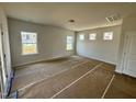 Spacious living room with plenty of natural light from multiple windows, ready for personalization at 40 Commons Cir, Clayton, NC 27520
