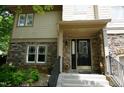 Charming home entrance with stone facade, front steps and attractive door at 4810 Glenmist Ct, Raleigh, NC 27612