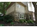 Landscaped side view of home showing brickwork and surrounding greenery at 4810 Glenmist Ct, Raleigh, NC 27612
