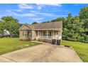 Charming single-story home with a welcoming front porch and well-maintained lawn and landscaping at 54 Lockwood Dr, Clayton, NC 27527