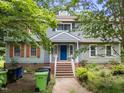 Charming home with a striking blue door, complemented by a well-maintained front yard at 5520 Kaplan Dr, Raleigh, NC 27606