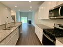 Open-concept kitchen featuring granite countertops, stainless steel appliances, and stylish finishes at 656 Barneswyck Dr, Fuquay Varina, NC 27526