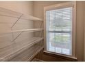 Walk-in pantry with adjustable wire shelving and a window for natural light at 656 Barneswyck Dr, Fuquay Varina, NC 27526