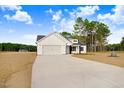 Beautifully designed one-story home with attached two-car garage and manicured front yard at 80 Birchtop Cir, Zebulon, NC 27597