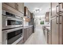 Modern kitchen boasts stainless steel appliances, sleek cabinetry, quartz countertops, and an oven at 800 Camden Ave, Durham, NC 27701