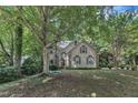 Traditional home with mature trees providing shade, offering a serene and private setting at 100 Windvale Ct, Cary, NC 27518