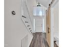 Spacious foyer featuring a staircase, light-filled entry, and a charming barn door to the restroom at 100 Windvale Ct, Cary, NC 27518