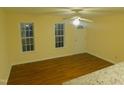 Cozy living space featuring wood floors, ceiling fan, natural light, and access to kitchen at 1098 Blackstone Dr, Creedmoor, NC 27522