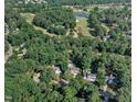 Expansive aerial view of a residential area near Prestwood Golf Course, surrounded by lush greenery and serene lakes at 115 E Seve Ct, Morrisville, NC 27560