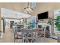 Bright dining area featuring a wood table, white chairs, a fireplace, and an open-concept kitchen at 115 E Seve Ct, Morrisville, NC 27560