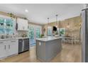 Charming kitchen with stainless steel appliances, island, and eat in dining area at 115 E Seve Ct, Morrisville, NC 27560