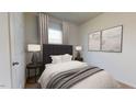 Cozy bedroom with neutral decor, carpet, and ample natural light from the window at 138 N Keatts Winner Ct, Clayton, NC 27520