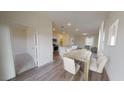 Open concept dining area with wood floors and views of the kitchen and living room at 138 N Keatts Winner Ct, Clayton, NC 27520