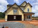 New two-story home featuring a two-car garage and a classic facade at 1413 Malcus Ct # 61, Fuquay Varina, NC 27526