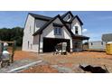 Two-story home featuring a modern farmhouse design with white siding and a two-car garage at 1413 Malcus Ct # 61, Fuquay Varina, NC 27526