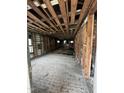 Exposed framing and unfinished floor of the home's interior, offering a glimpse of renovation potential at 1521 Lewis St, Rocky Mount, NC 27804