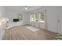 Bright living room featuring hardwood floors, large windows and neutral wall paint at 1832 Blandwood Dr, Rocky Mount, NC 27801