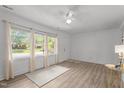 Inviting living area boasting hardwood floors, natural light from large windows, and a ceiling fan at 1832 Blandwood Dr, Rocky Mount, NC 27801
