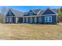 New construction home boasts a stylish gray exterior, inviting porch, and ample natural light at 193 Jim S Rd, Cameron, NC 28326