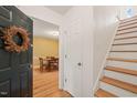Inviting entryway with hardwood floors, stairs, and a view of the dining room at 20 Timberlyne Rd, Chapel Hill, NC 27514