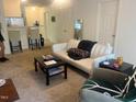 Comfortable living room with neutral carpet, sofa, coffee table, and adjacent dining area at 2000 University Woods Rd # 203, Raleigh, NC 27603