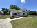 Charming single Gathering home featuring a well-maintained lawn and concrete driveway at 202 S Pearl St, Princeton, NC 27569