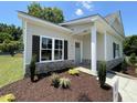 Attractive single story home with beautiful landscaping, stone accents, and a covered porch at 202 S Pearl St, Princeton, NC 27569