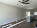 Spacious living room with hardwood floors, ceiling fan, and a bright, airy feel at 202 S Pearl St, Princeton, NC 27569