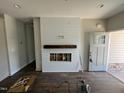 Bright living room featuring a decorative fireplace with a wood mantel and shiplap surround at 202 S Pearl St, Princeton, NC 27569