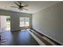 Hardwood floors and lots of natural light make this living room a great place to relax at 202 S Pearl St, Princeton, NC 27569