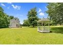 Large backyard features a gazebo and plenty of green space at 209 Bradley Dr, Benson, NC 27504