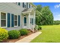 Inviting front porch with white railings and a well-maintained garden at 209 Bradley Dr, Benson, NC 27504