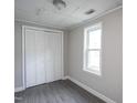 Bedroom featuring updated flooring, a window for natural light, and a closet at 306 W Main St, Pine Level, NC 27568