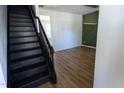 Inviting entryway featuring staircase and newly installed hardwood floors at 328 Mccarthy Dr, Clayton, NC 27527