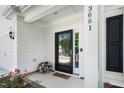 Inviting front door entrance with black trim, 'hello' door mat, and a flower pot at 3661 Manifest Pl, Cary, NC 27519