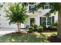 Inviting front porch with a black front door and verdant shrubbery at 3661 Manifest Pl, Cary, NC 27519