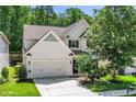 Beautiful two-story home featuring a well-manicured lawn, two-car garage and mature landscaping at 3661 Manifest Pl, Cary, NC 27519
