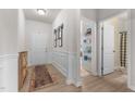 Welcoming entryway featuring wood-look floors, decorative accents, leading to an open hallway and bathroom at 41 Liam Dr, Broadway, NC 27505