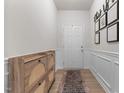 Stylish entryway with wood-look floors, paneling, decorative accents, and a welcoming atmosphere at 41 Liam Dr, Broadway, NC 27505