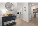 Inviting entryway with stylish furniture and view into the kitchen and laundry room for a modern feel at 41 Liam Dr, Broadway, NC 27505