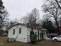 Well-maintained home exterior with landscaped yard, a welcoming side-view and attached carport at 6908 Park Pl, Raleigh, NC 27616