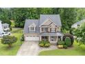 Beautiful brick home with mature trees, a two-car garage, and well-maintained landscaping at 7336 Capulin Crest Dr, Apex, NC 27539